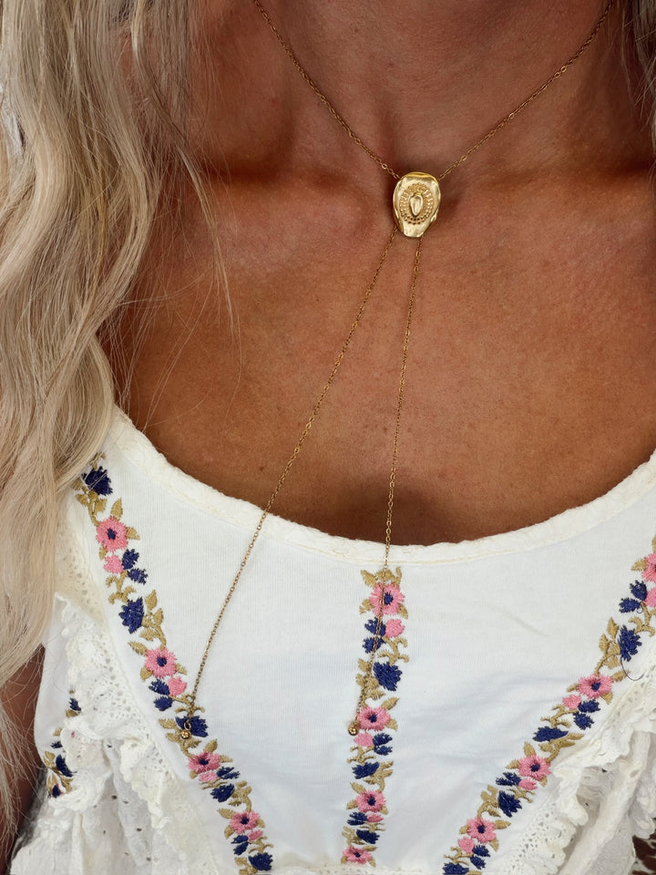 Gold adjustable necklace featuring a dainty cowboy hat pendant with a delicate chain.